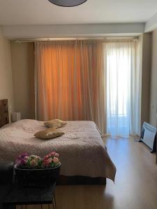 a bedroom with a large bed with flowers on it at studio in Itʼkhvisi
