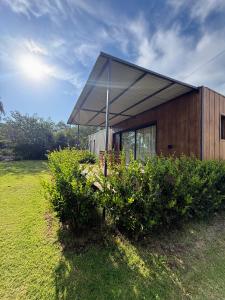 a small building with a canopy on top of a field at Casa Cajita in Rancul