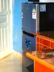 a refrigerator with a bunch of stickers on it at Hecahomes in Kericho