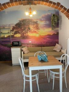 a living room with a table and a tree mural at Pisolo in Procchio