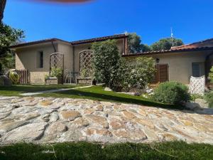 a house with a stone driveway in front of it at Pisolo in Procchio