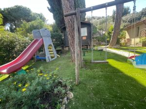 a playground with a slide in a yard at Pisolo in Procchio