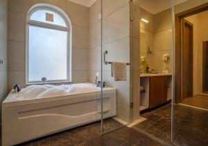 a large bathroom with a tub and a window at Maanya by the Lake By Samav hotels in Udaipur +43 photos