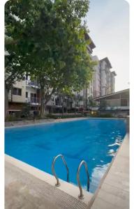 a swimming pool with blue water in a building at Matina enclaves condo studio type 6thfloor in Davao City