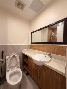 a bathroom with a toilet and a sink and a mirror at Matina enclaves condo studio type 6thfloor in Davao City +12 photos