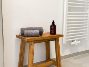 a bottle of wine sitting on a wooden table at Ferienwohnung Ufertraum am Dümmer See in Lembruch +20 photos