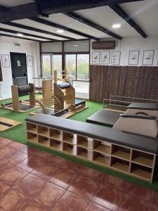 a room with a gym with chairs and tables at Hotel Move Espadan in Azuébar