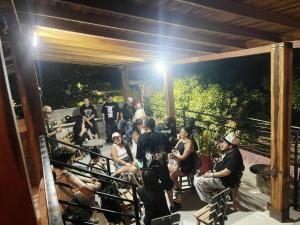 a group of people standing on a deck at night at Hotel Coralite Suites Santa Marta in Santa Marta