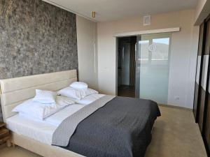 a bedroom with a bed with white sheets and pillows at Ośrodek Uzdrowiskowy Biawena in Wysowa-Zdrój