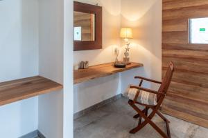 a room with a wooden counter and a chair at Reve Island Lodge in Grand Anse +23 photos