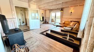 a living room with a wood stove and a couch at Penthouse Meeresrauschen in Dierhagen