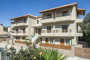 an apartment building with balconies and trees at EMERALD Luxury Living in Syvota