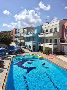 a large swimming pool in front of a building at Ilios Mare Hotel in Agia Marina Nea Kydonias