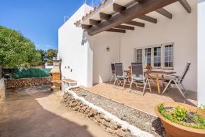 a patio with a table and chairs in a house at Casa Masi by 3VILLAS in Son Parc