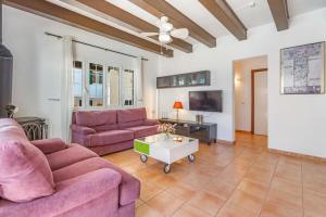 a living room with two pink couches and a coffee table at Casa Masi by 3VILLAS in Son Parc