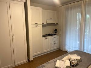 a kitchen with white cabinets and a counter top at Il Giardino di Daniela Apartments in San Teodoro +18 photos
