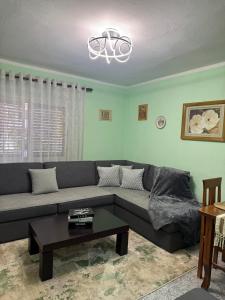 a living room with a couch and a table at Sweet Escape in Shkodër
