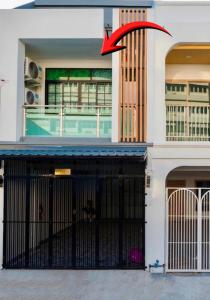 a building with a gate with a red arrow on it at 11 House - 9 mins drive to LeeGarden,parking available in Ban Kohong