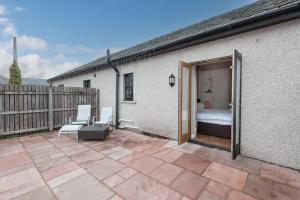 a patio with a bedroom and a bed and a fence at Sandfordarms in Appleby +16 photos