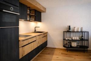 a kitchen with a sink and a counter at Chalet Höfi - Ski-in Ski out at Hörnlilift by Arosa Stay in Arosa