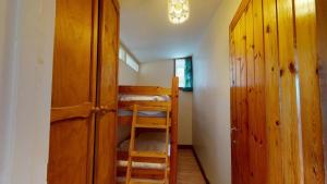 a room with two bunk beds and a ladder at C19 Old Range, Riviere Towans in Hayle