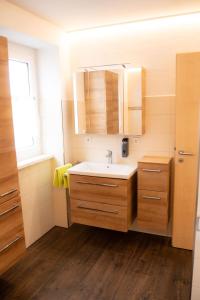 a bathroom with a sink and a mirror at Hotel zur Post e.K. in Waischenfeld +53 photos