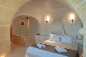 a bedroom with a bed and a bath tub at Cypresses Villas in Áno Gatzéa