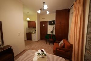 a room with a living room and a kitchen at Artemis Traditional Hotel in Myrina