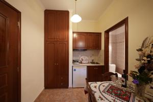 a kitchen with a table and a counter top at Artemis Traditional Hotel in Myrina +50 photos