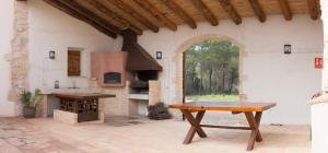 a large patio with an outdoor oven in a house at Casa rural Masia Les Apieres. in El Pla de Manlleu