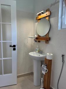 a bathroom with a sink and a mirror at Koçeku Brothers Guest House in Fushë-Lurë +47 photos