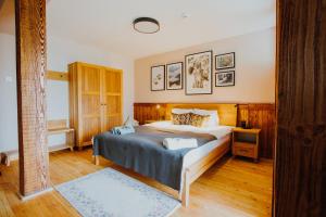 a bedroom with a large bed with a wooden headboard at Equus Silvania in Şinca Nouă