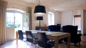 a dining room with a table and chairs at La Colombière in Lurcy-le-Bourg +16 photos