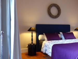 a bedroom with two beds and a mirror on the wall at La Colombière in Lurcy-le-Bourg