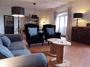 a living room with a couch and a table at La Colombière in Lurcy-le-Bourg