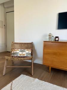 a room with a rattan chair next to a dresser at Casa MauRo in Senigallia