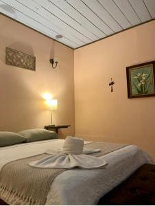 a room with two beds with a towel on the bed at La Estancia Ideal Apartamentos in Fortuna