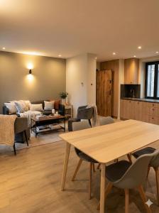 a living room with a table and a couch at Sandstone in Noisy-sur-École