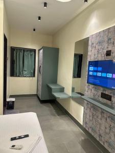 a hospital room with a tv and a fireplace at Hotel Vyankatesh Inn in Nashik