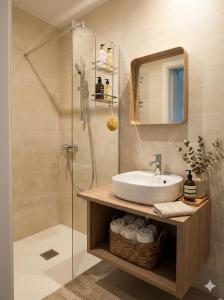 a bathroom with a sink and a shower at Sandstone in Noisy-sur-École