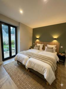 two beds in a large bedroom with a large window at Sandstone in Noisy-sur-École +36 photos