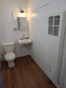 a bathroom with a toilet and a sink at Terry Point Motel in Richfield +41 photos