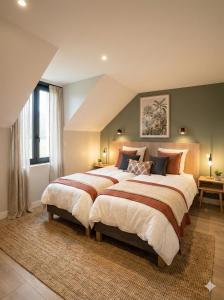 a large bedroom with two beds in it at Sandstone in Noisy-sur-École