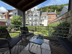 a balcony with chairs and a view of a building at Chez JAJA in Malmedy