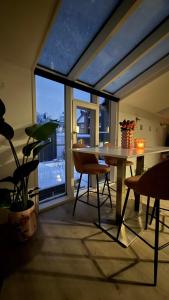 a dining room with a table and a large window at Chez JAJA in Malmedy