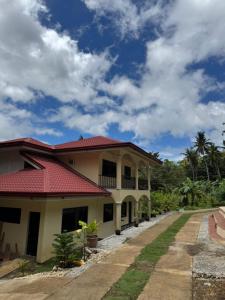 a house with a red roof at Villa Nicolasa in Siquijor