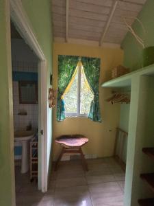 a small room with a window and a chair at Soufriere Guesthouse in Soufrière +57 photos