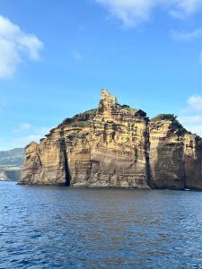 a large rock formation in the middle of the water at Casa Veleiro SHALOM in Ponta Delgada +24 photos