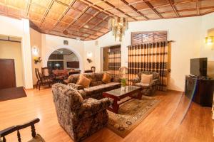 a living room with a couch and a table at Anaya Villa in Nuwara Eliya