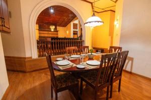 a dining room with a table with chairs and a dining room at Anaya Villa in Nuwara Eliya
